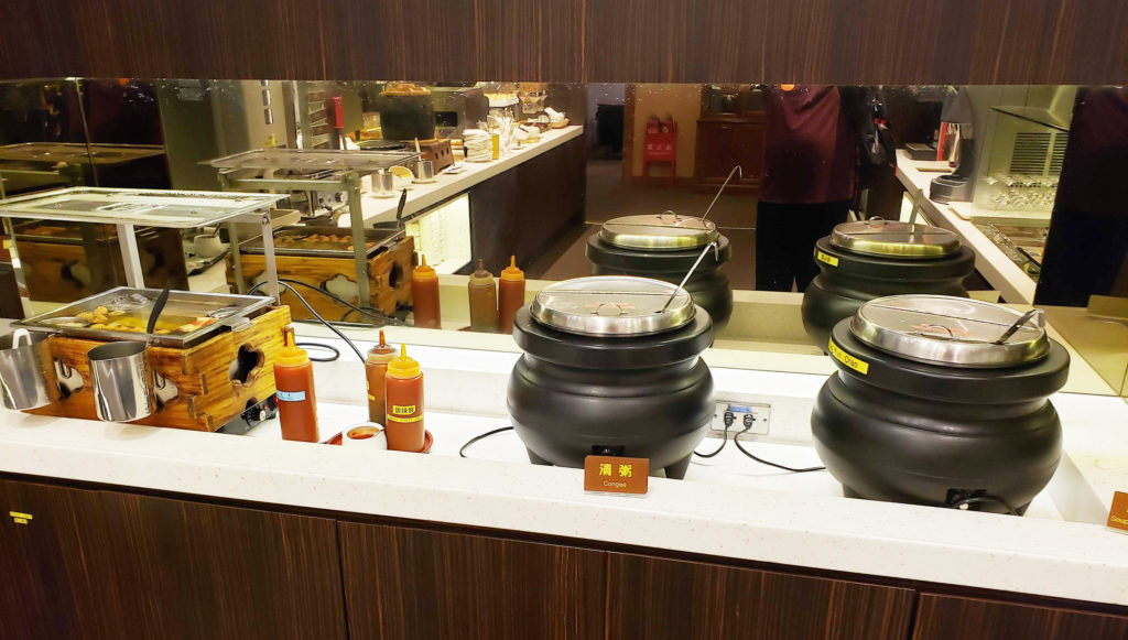a group of black pots with lids on a counter