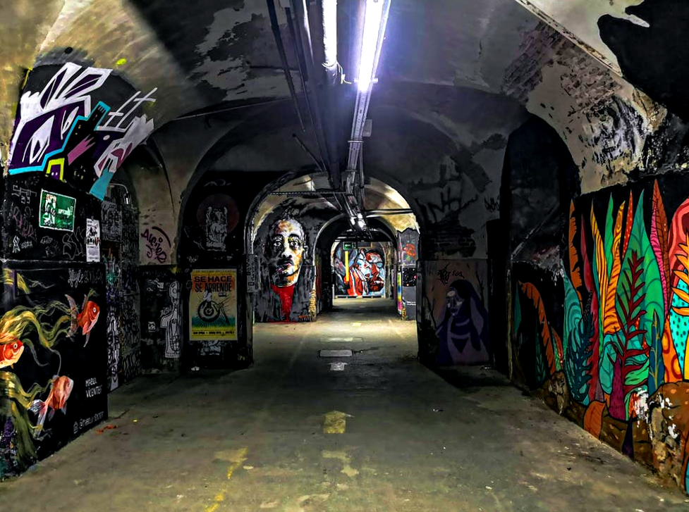 a tunnel with graffiti on the walls