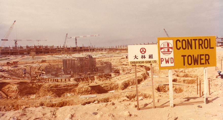 a construction site with signs and cranes