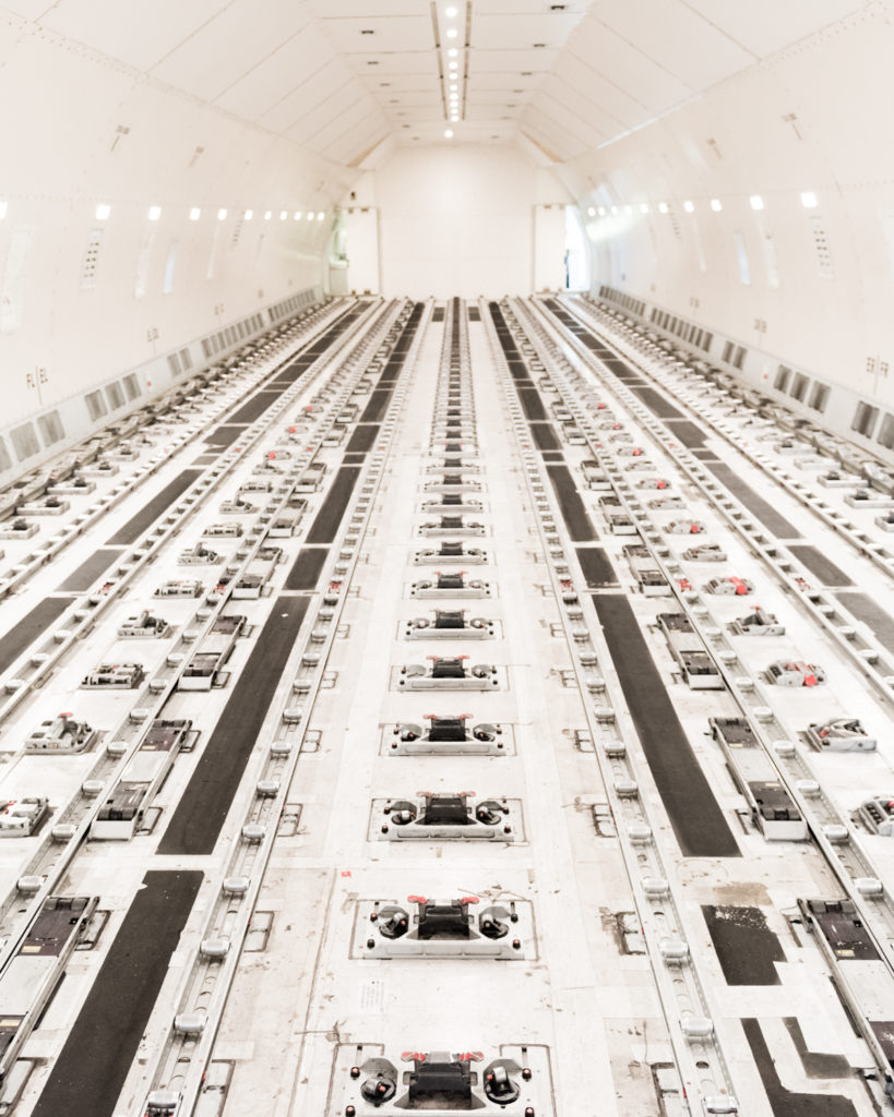 a large white room with rows of machinery
