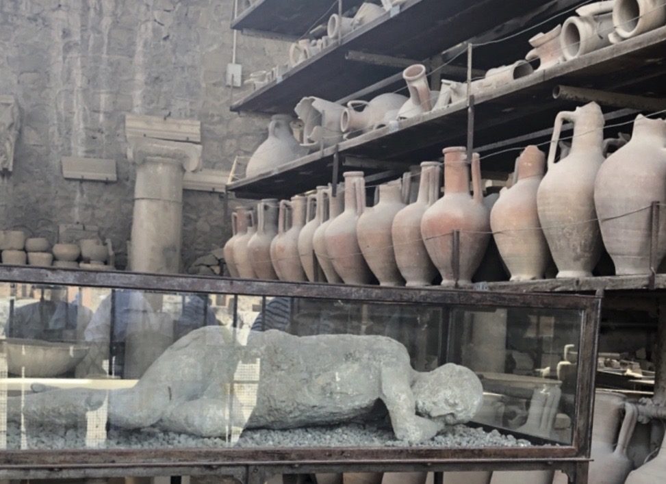 a group of clay pots and vases on shelves