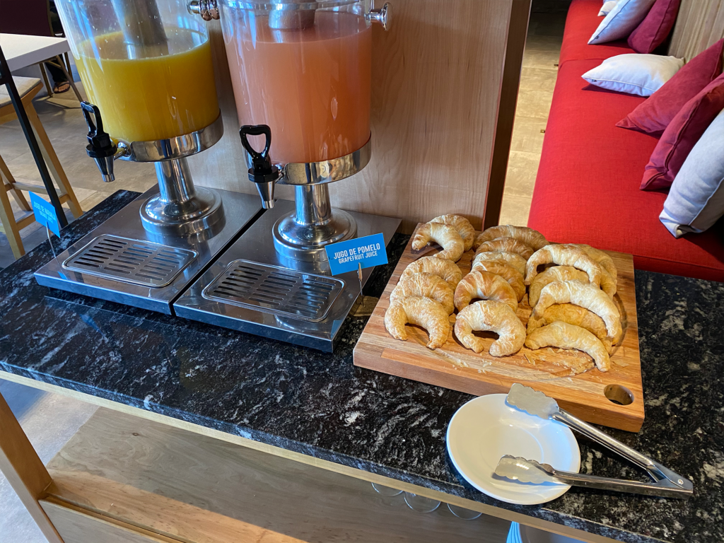 Hampton by Hilton Bariloche breakfast buffet croissants and juices. Photo by author | Point Me To The Plane.