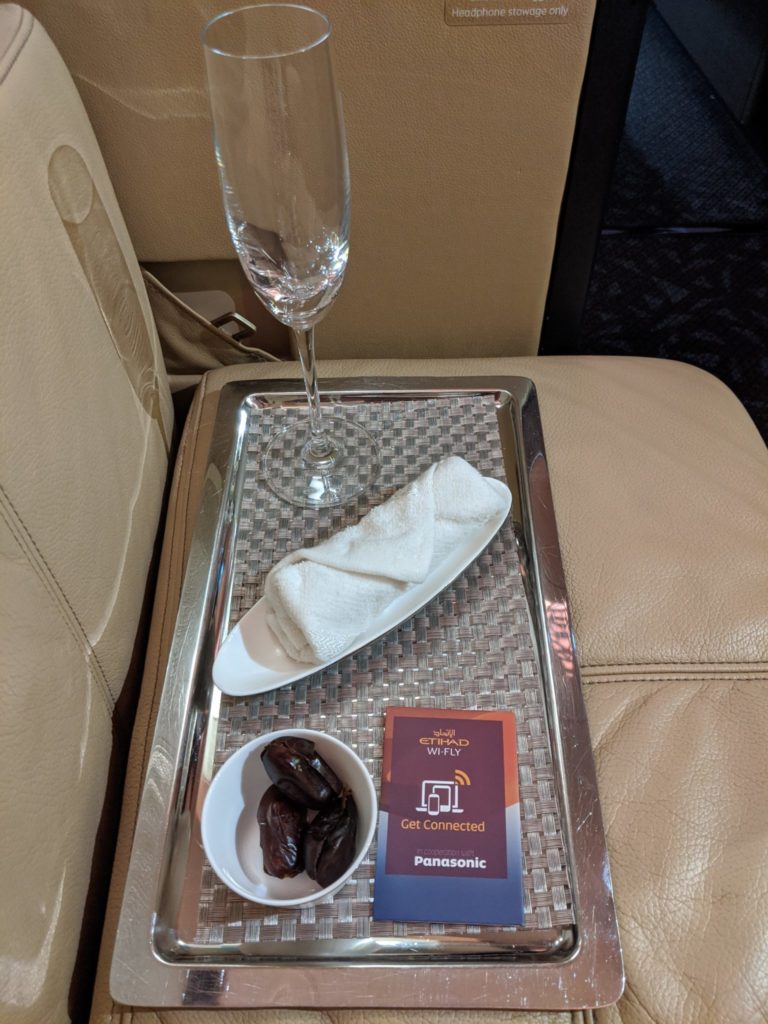 a tray with food and a glass on it