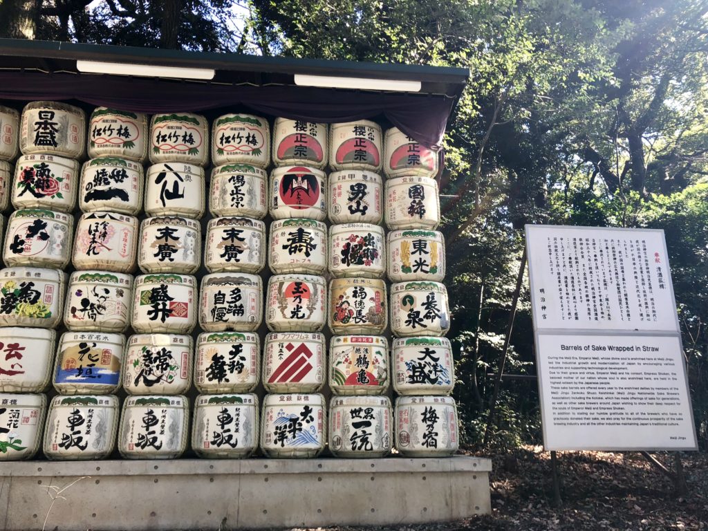 a large stack of barrels with writing on them