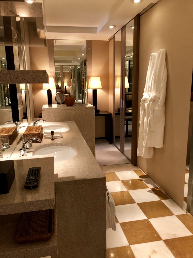 a bathroom with a white robe on the wall