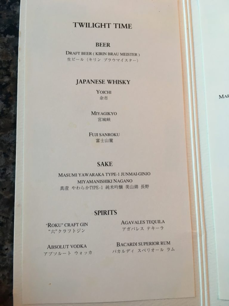 a menu of drinks on a counter