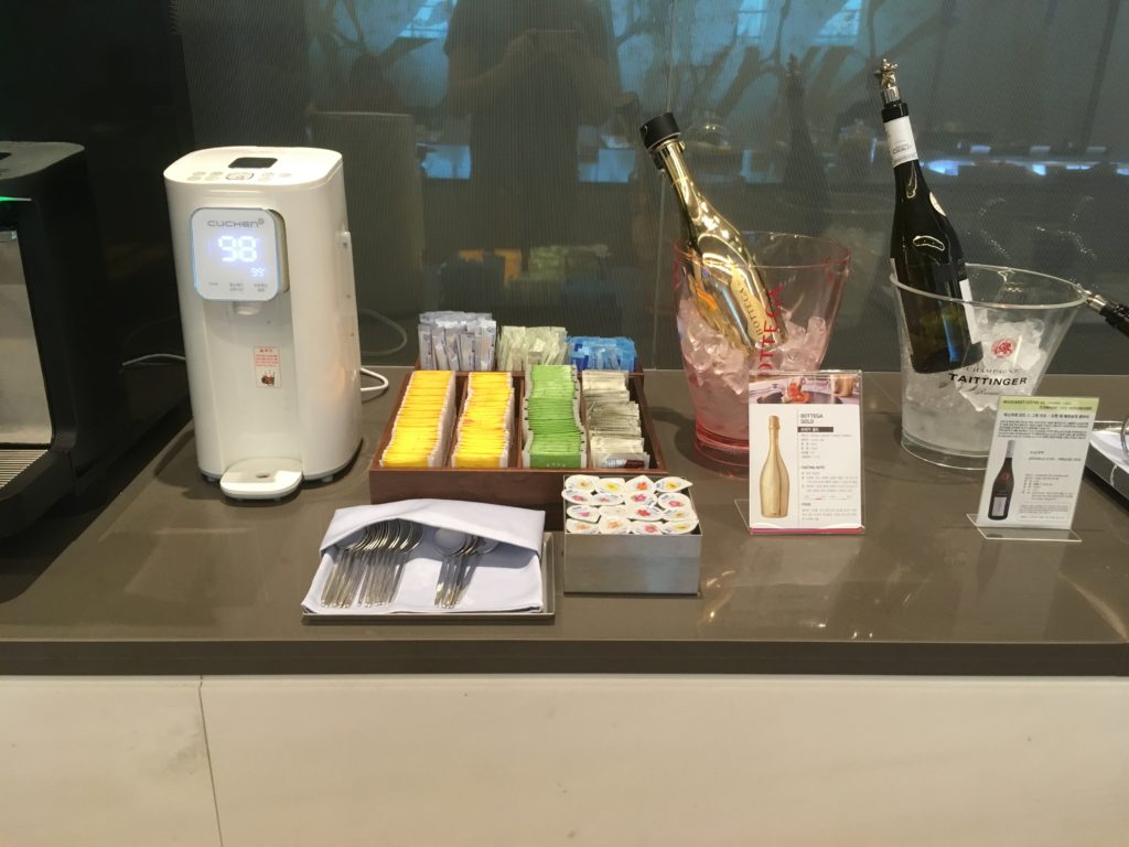 a table with a bottle of champagne and a thermometer