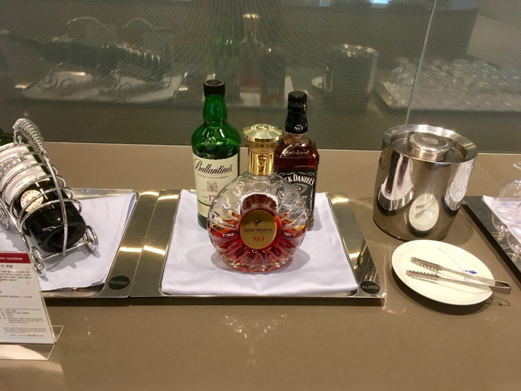 a tray with a glass bottle and a glass pitcher on it