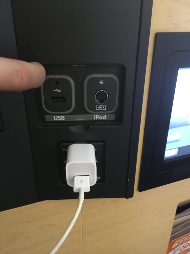 a finger pointing at a plug in device