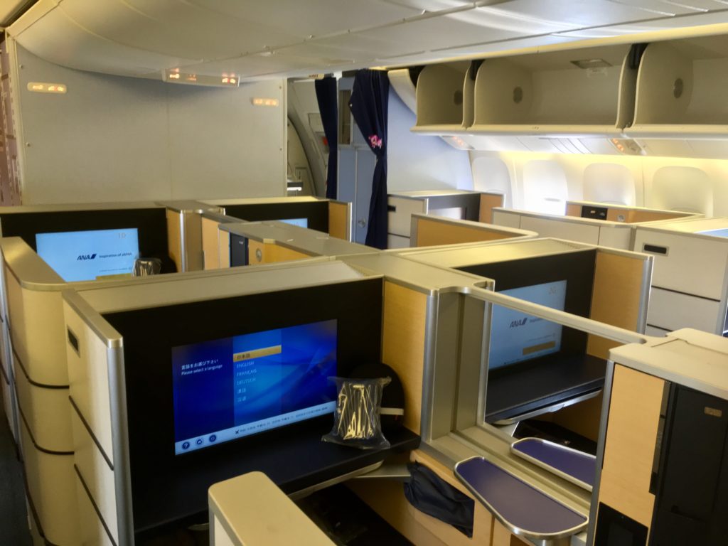 an airplane with a computer desk and chairs