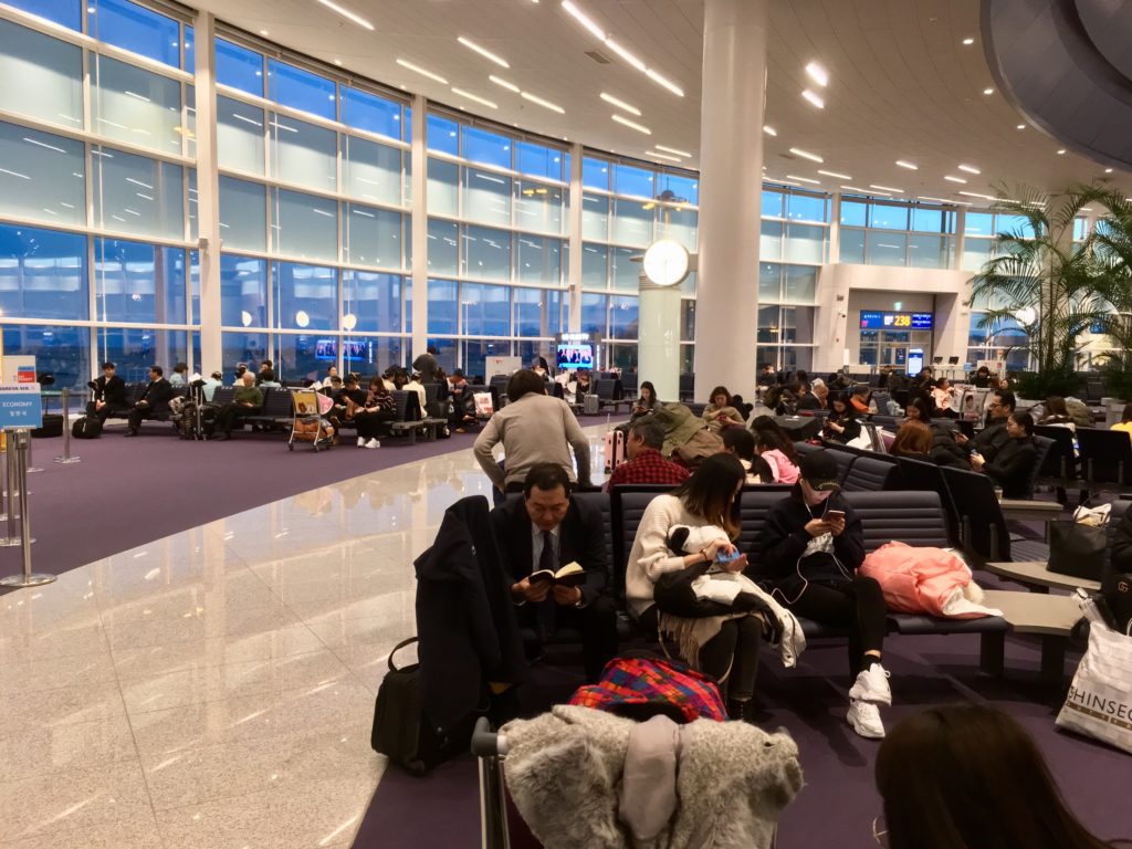 a group of people sitting on benches in a terminal