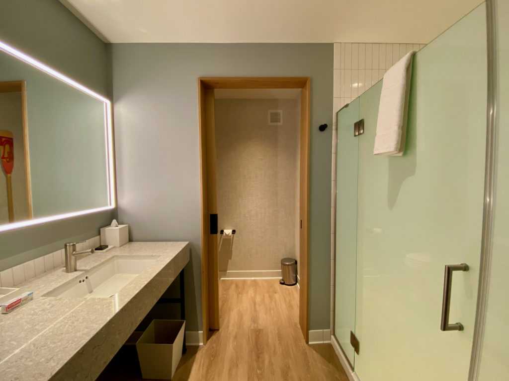 a bathroom with a glass shower door and sink