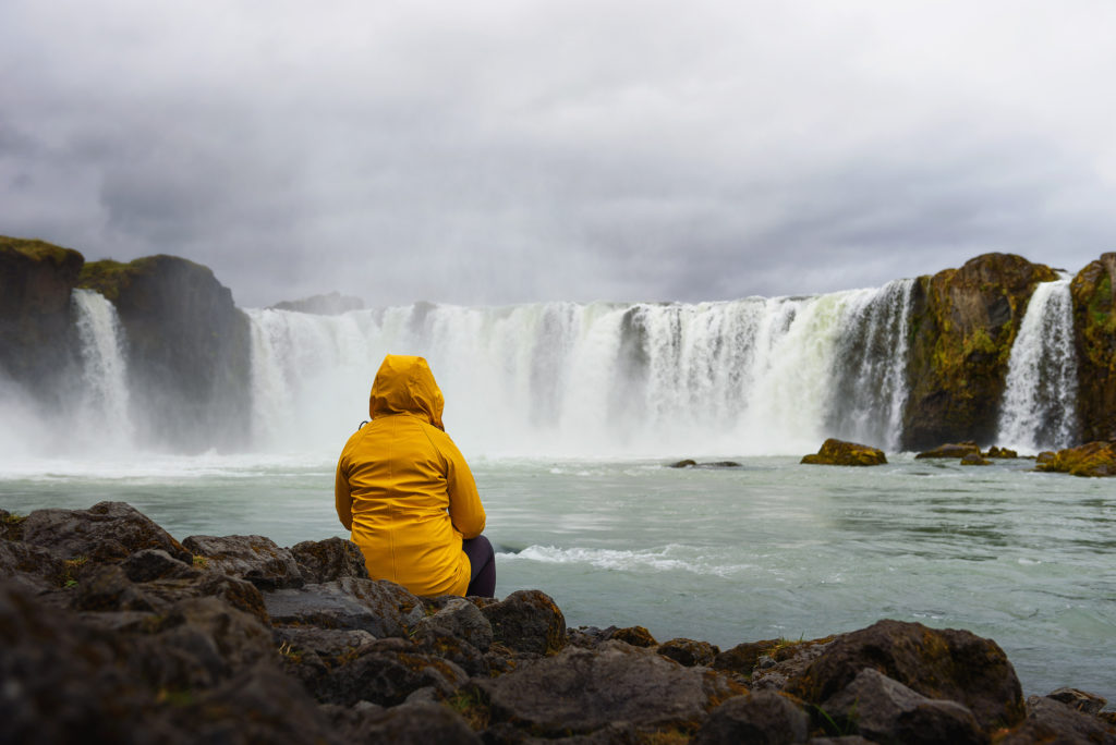 Relaxing At The Godafoss Waterfall In Iceland