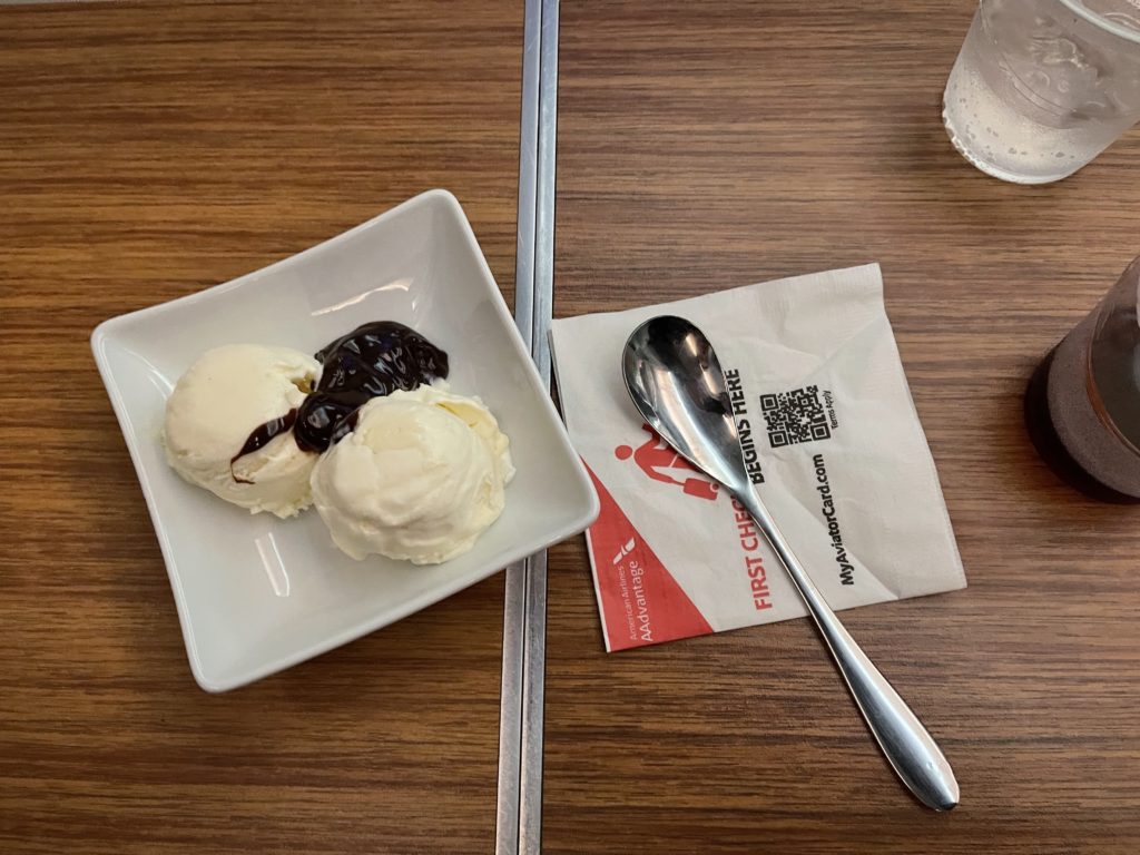 a bowl of ice cream and spoon on a table