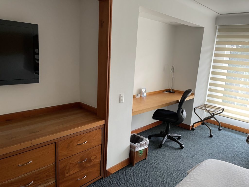 a room with a desk and a tv
