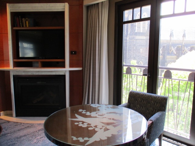 Park Hyatt Melbourne table in suite room with fireplace and tv