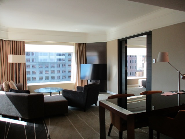 Grand Hyatt Melbourne living room with television and table