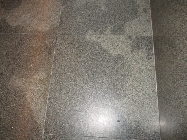 a close-up of a grey tile floor