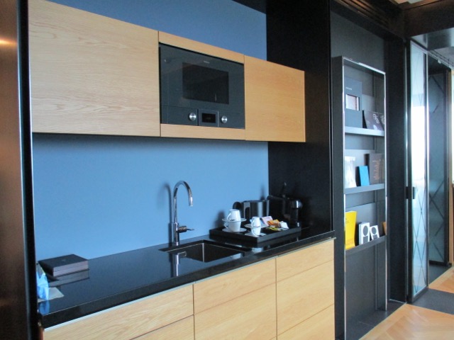Suite kitchen with a black countertop and a black sink
