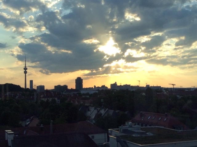 Munich city skyline with clouds and sun