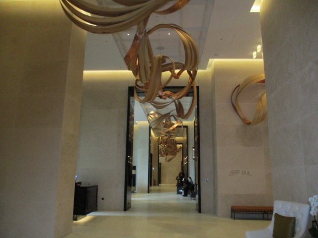 The Park Hyatt London lobby is long and narrow with elevators at one end and the restaurant at the other end